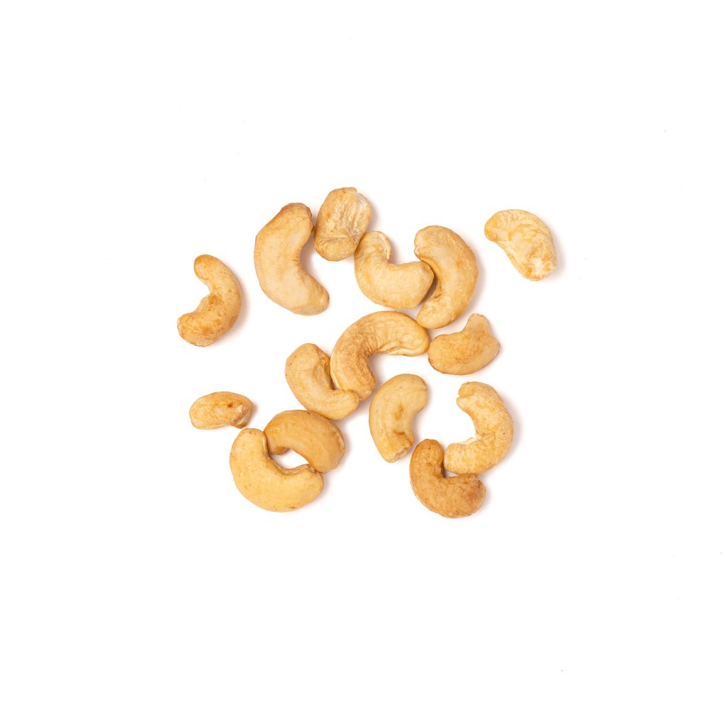 Cashew nuts on a white background, top view